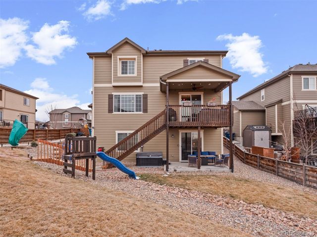 a view of multiple houses with a table and chairs