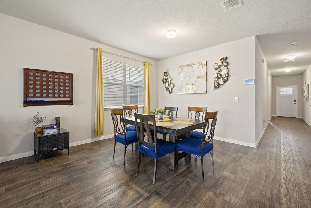 204 Rochester Lane Hutto, TX 78634 - Photo 12 of 40 Dining room with dark wood-type flooring and a textured ceiling