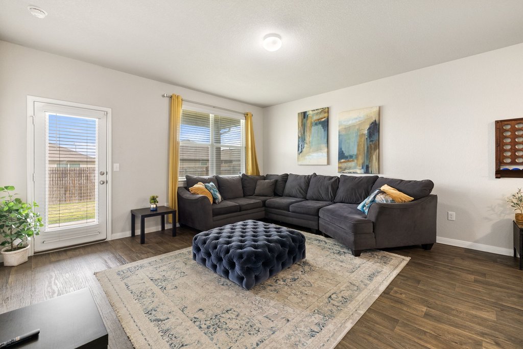 204 Rochester Lane Hutto, TX 78634 - Photo 16 of 40 Living room featuring wood finished floors and baseboards