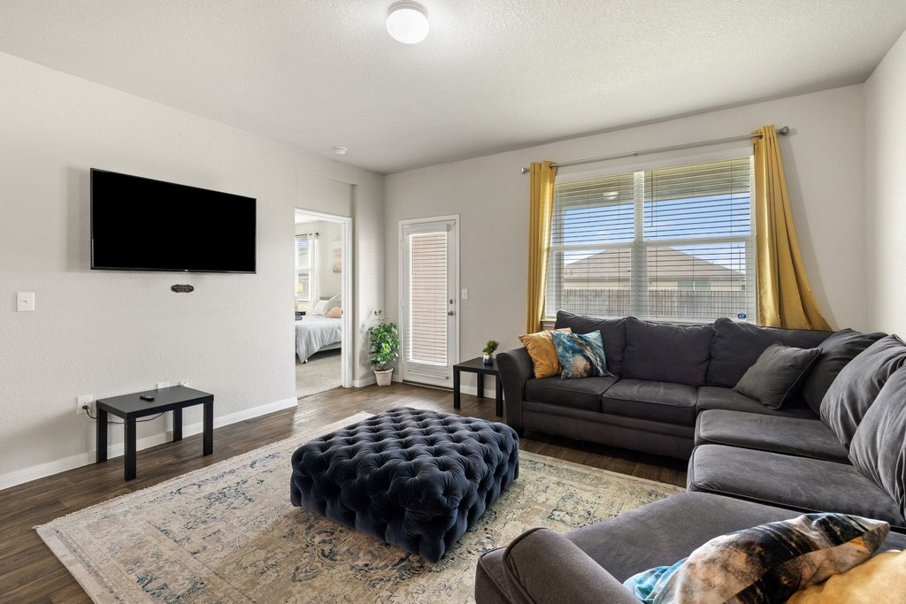 204 Rochester Lane Hutto, TX 78634 - Photo 17 of 40 Living area featuring wood finished floors and a textured ceiling