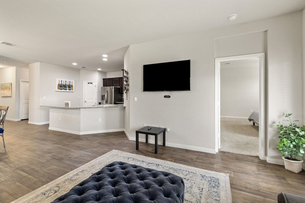 204 Rochester Lane Hutto, TX 78634 - Photo 19 of 40 Living room with dark wood-style floors and recessed lighting