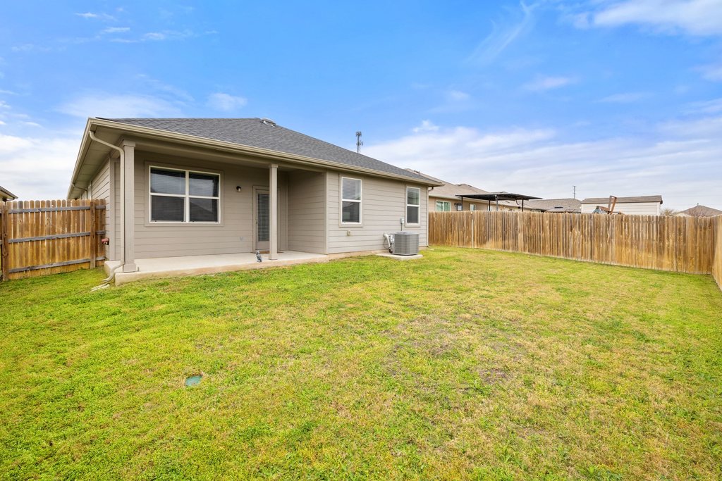 204 Rochester Lane Hutto, TX 78634 - Photo 37 of 40 Rear view of house with a patio, a fenced backyard, and roof with shingles
