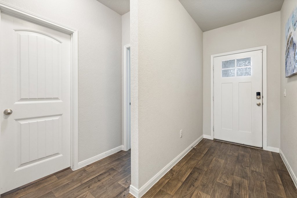 204 Rochester Lane Hutto, TX 78634 - Photo 5 of 40 Foyer entrance featuring dark wood-style floors and baseboards