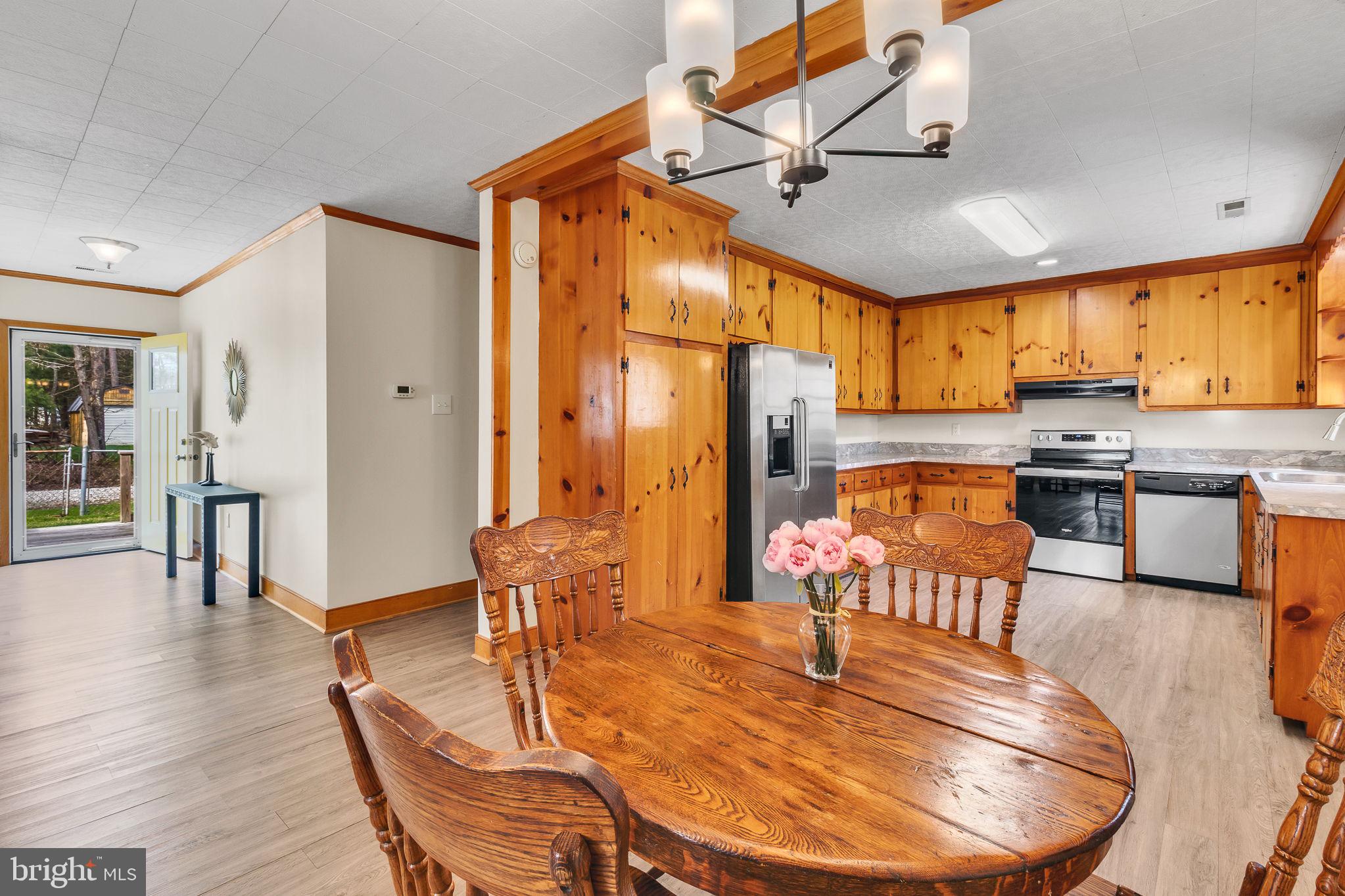 239 Lane Road Reedville, VA 22539 - Photo 12 of 61 a living room with stainless steel appliances kitchen island granite countertop furniture and a kitchen view