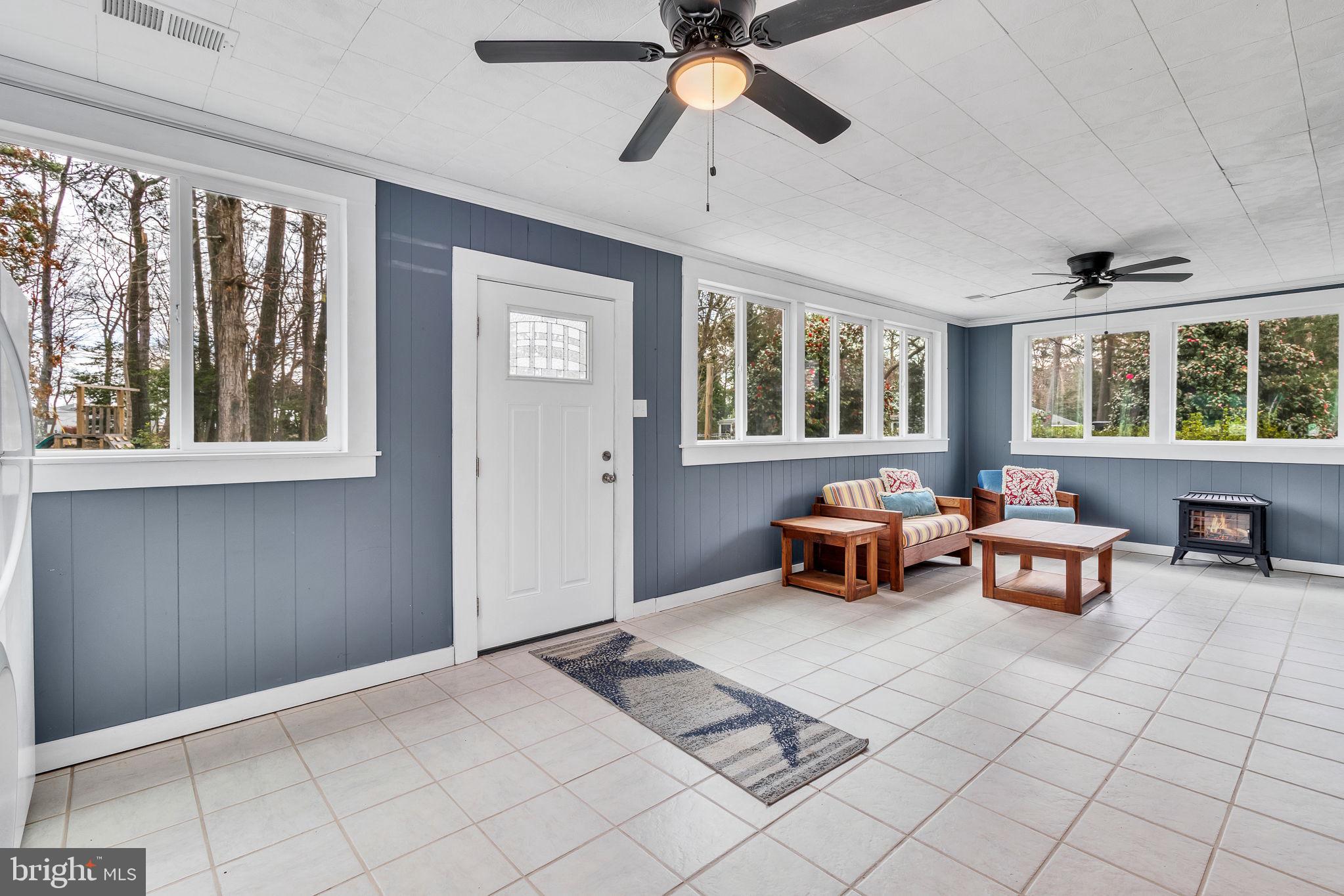 239 Lane Road Reedville, VA 22539 - Photo 14 of 43 Bright sunroom with serene views.