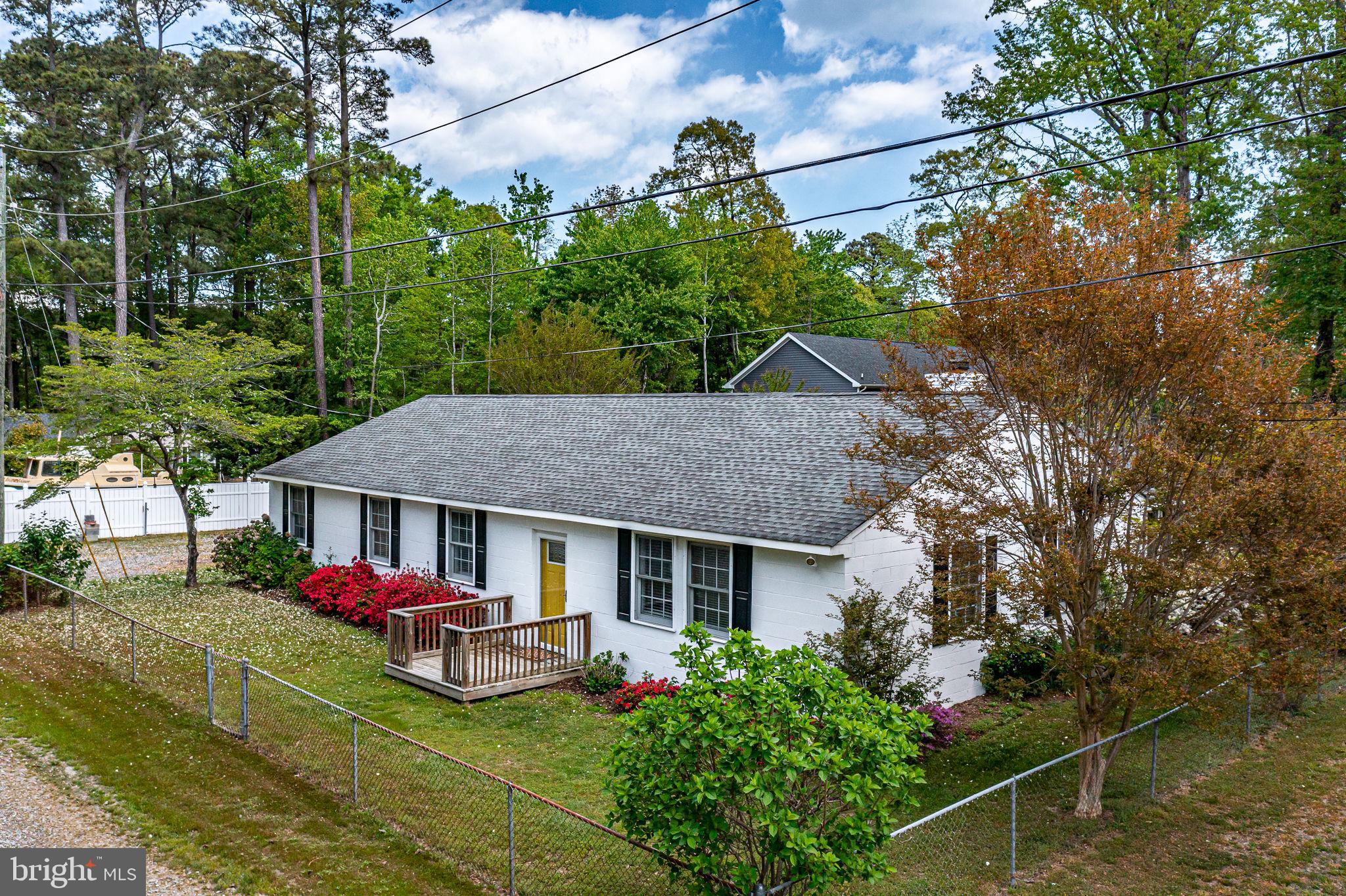 239 Lane Road Reedville, VA 22539 - Photo 2 of 61 Charming home with vibrant landscaping.