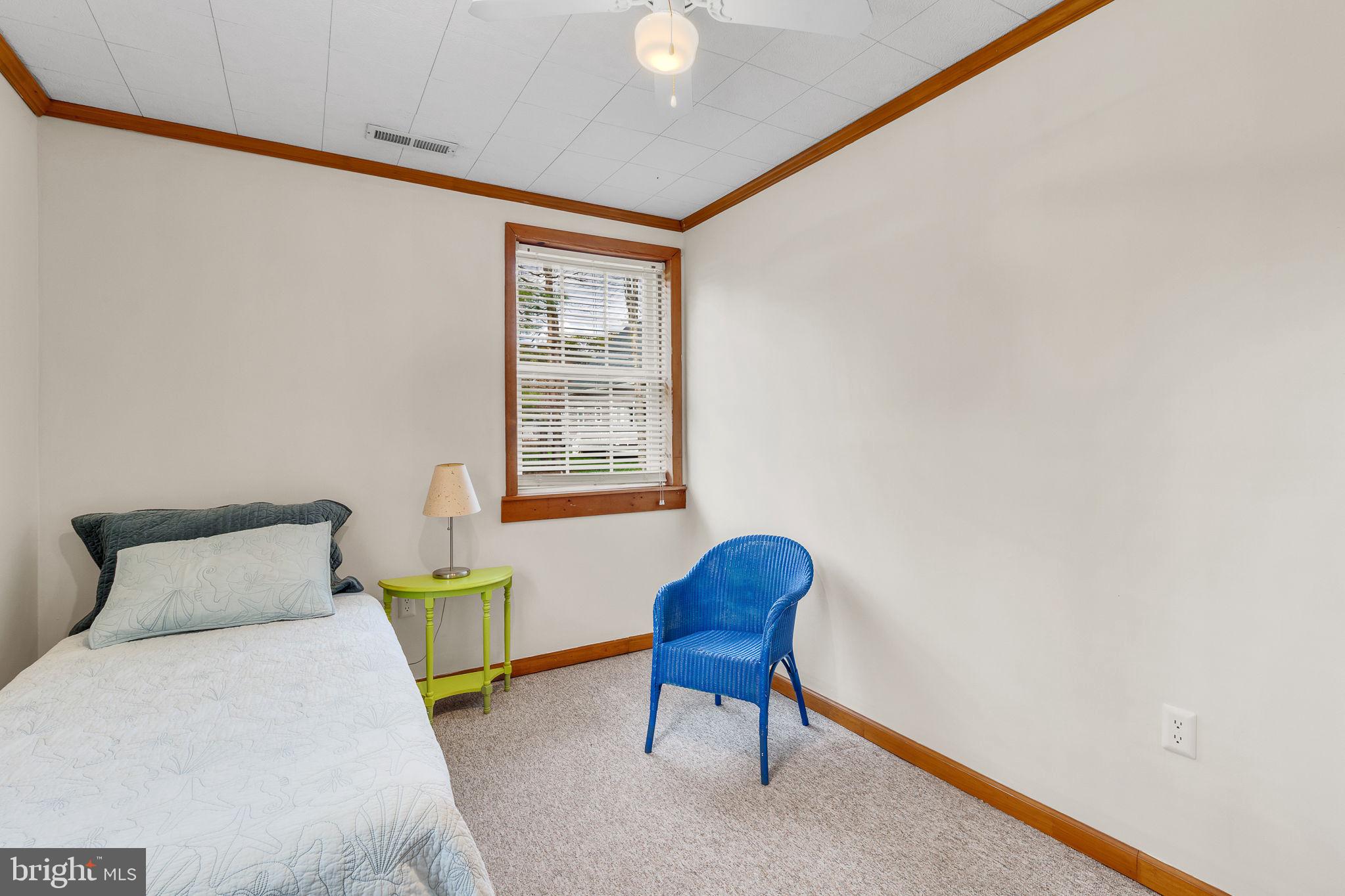 239 Lane Road Reedville, VA 22539 - Photo 22 of 61 a bedroom with a bed a table and chair