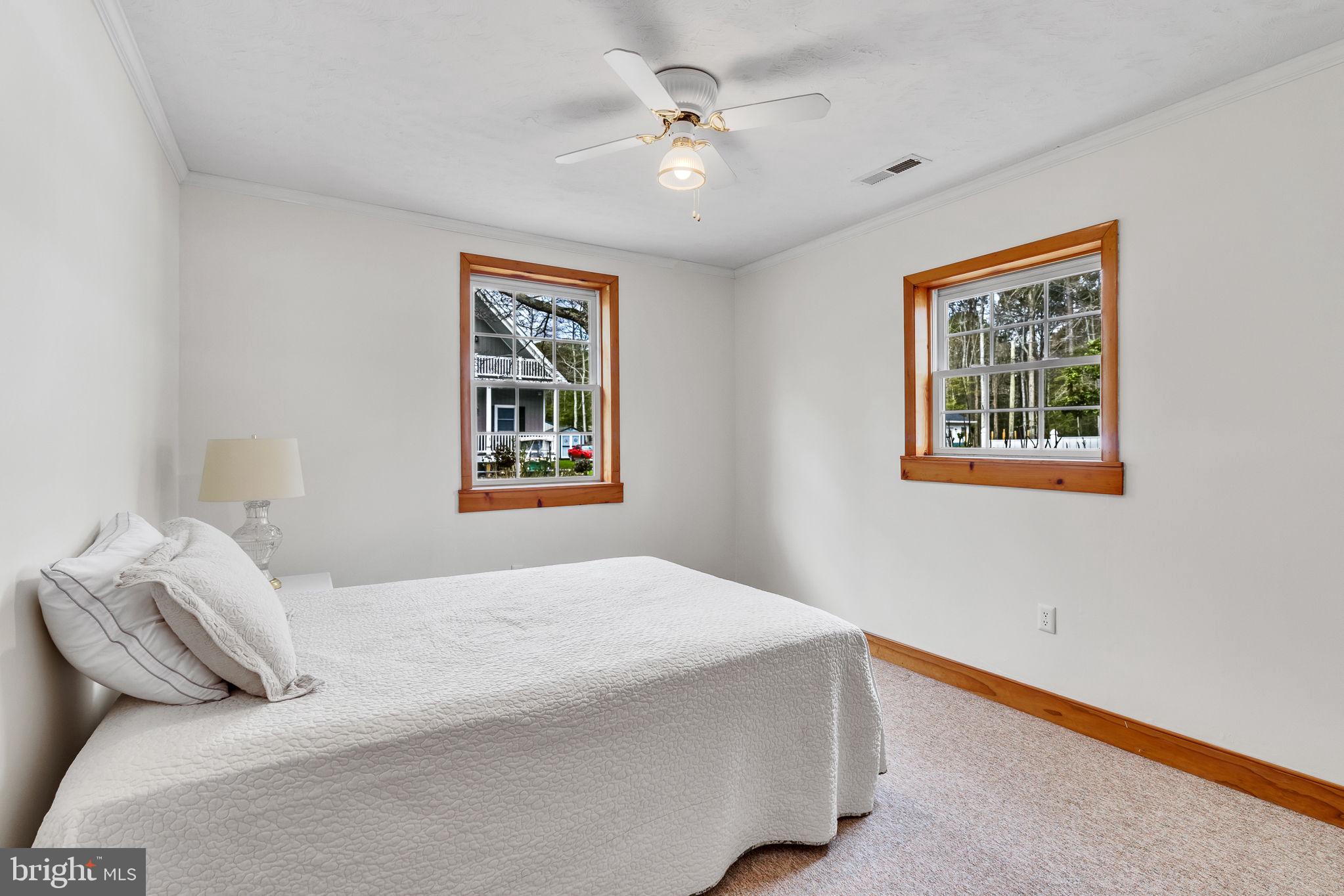 239 Lane Road Reedville, VA 22539 - Photo 28 of 61 a bedroom with a large bed and a window