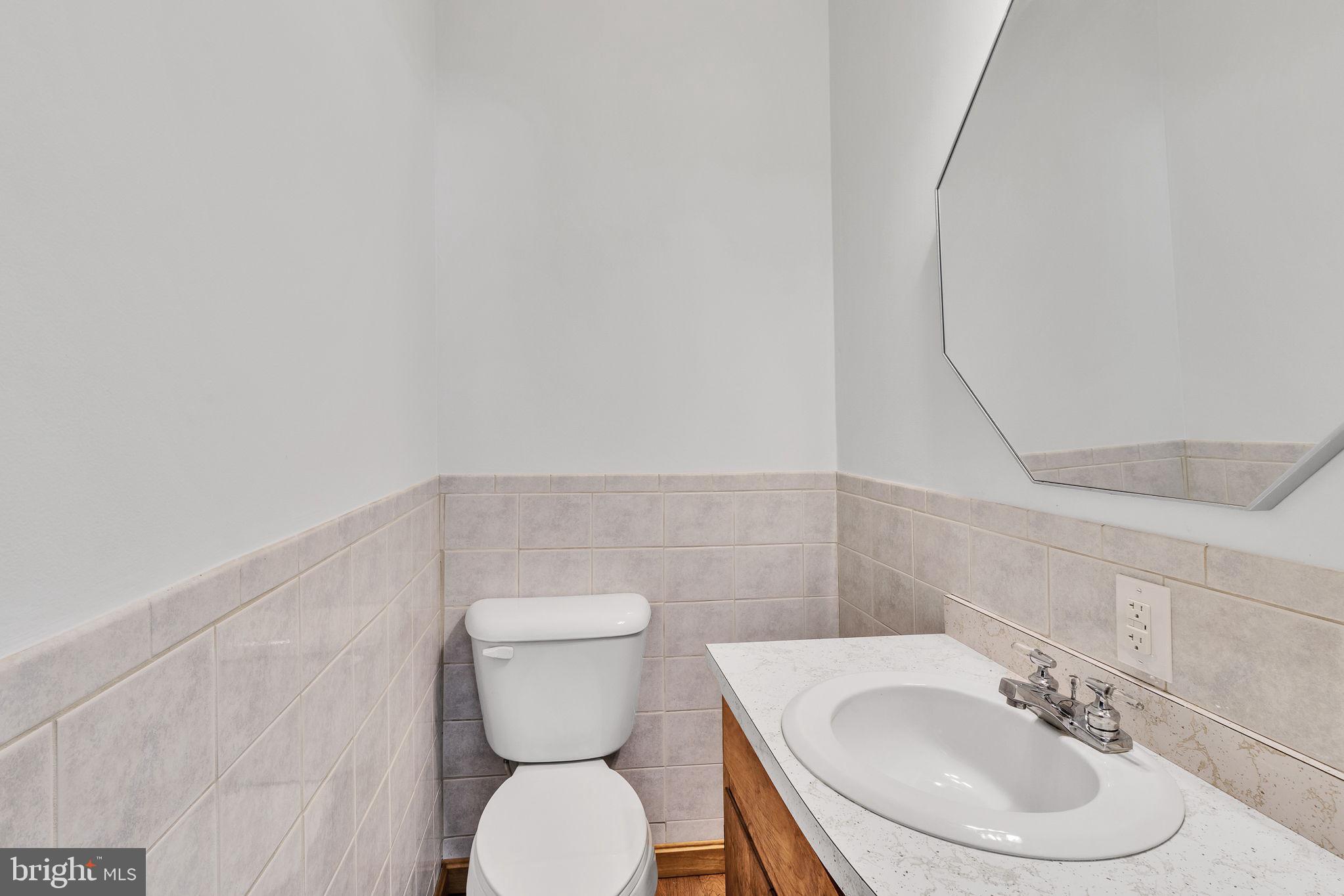 239 Lane Road Reedville, VA 22539 - Photo 32 of 61 a bathroom with a sink mirror and toilet