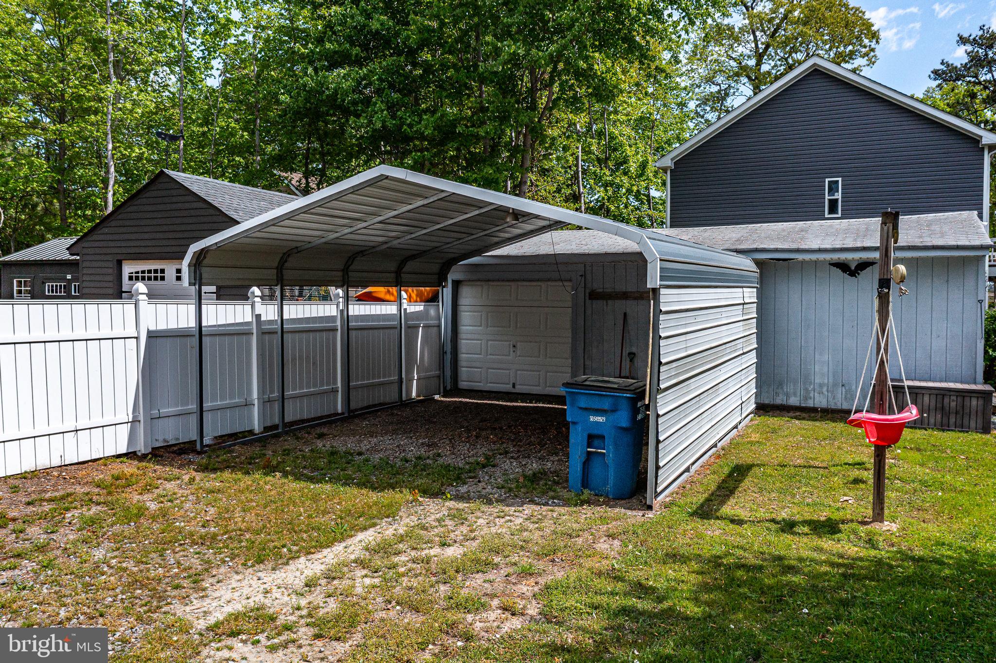 239 Lane Road Reedville, VA 22539 - Photo 39 of 61 Spacious carport in a serene setting.