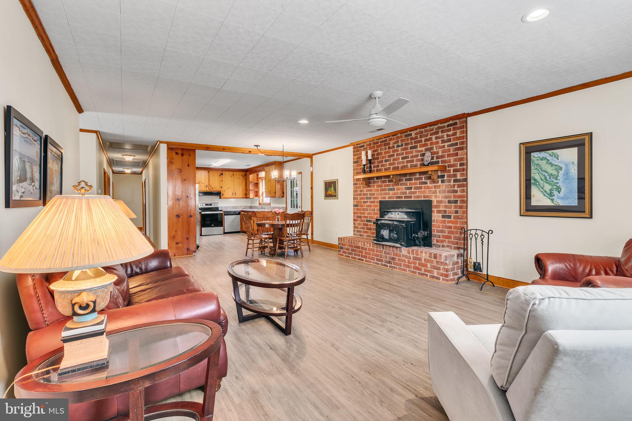 239 Lane Road Reedville, VA 22539 - Photo 4 of 61 a living room with furniture a fireplace and a flat screen tv