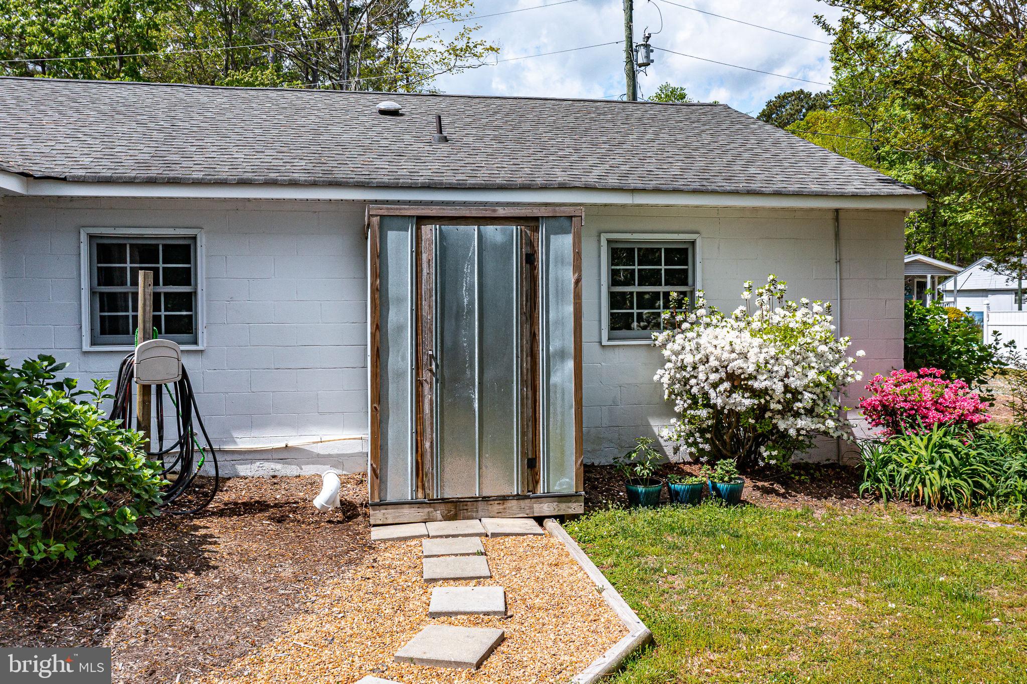 239 Lane Road Reedville, VA 22539 - Photo 44 of 61 Charming garden shed entrance awaits.