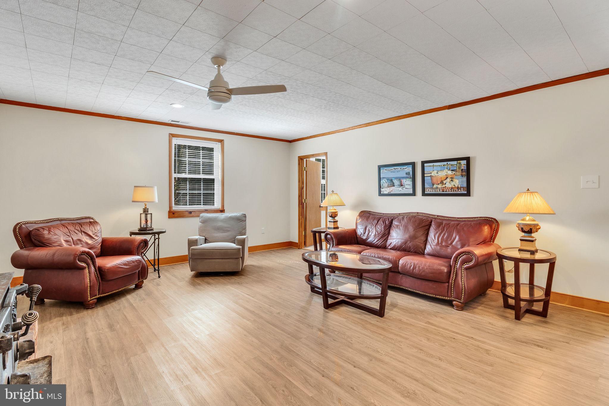 239 Lane Road Reedville, VA 22539 - Photo 5 of 61 a living room with furniture and a lamp