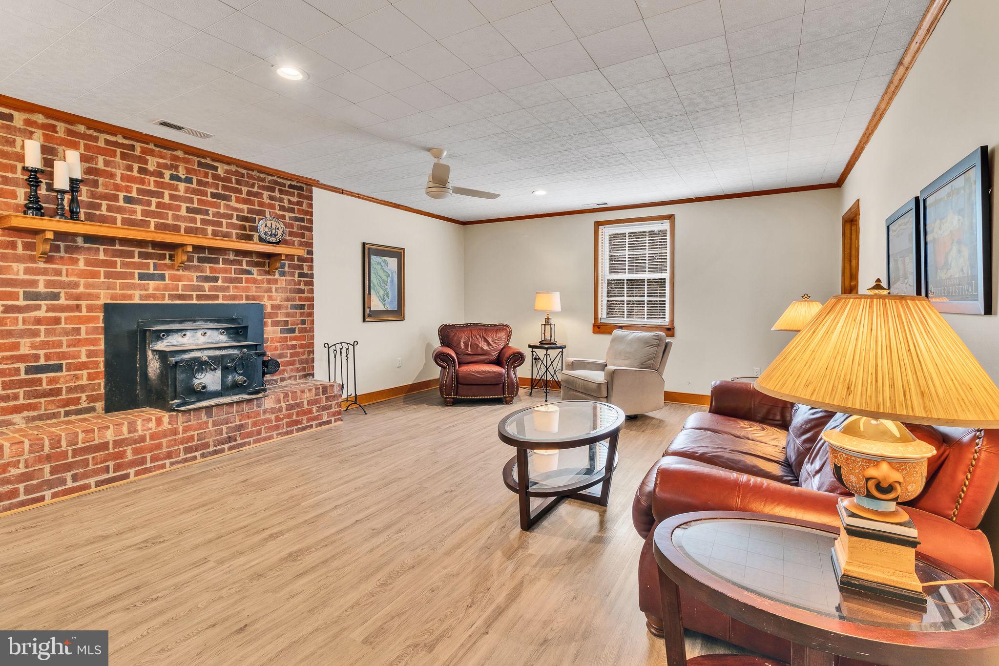 239 Lane Road Reedville, VA 22539 - Photo 6 of 61 a living room with furniture and a fireplace