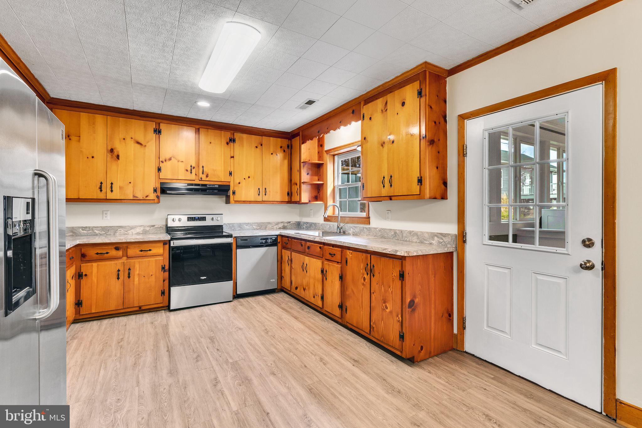 239 Lane Road Reedville, VA 22539 - Photo 8 of 43 Warm wood tones in a cozy kitchen.