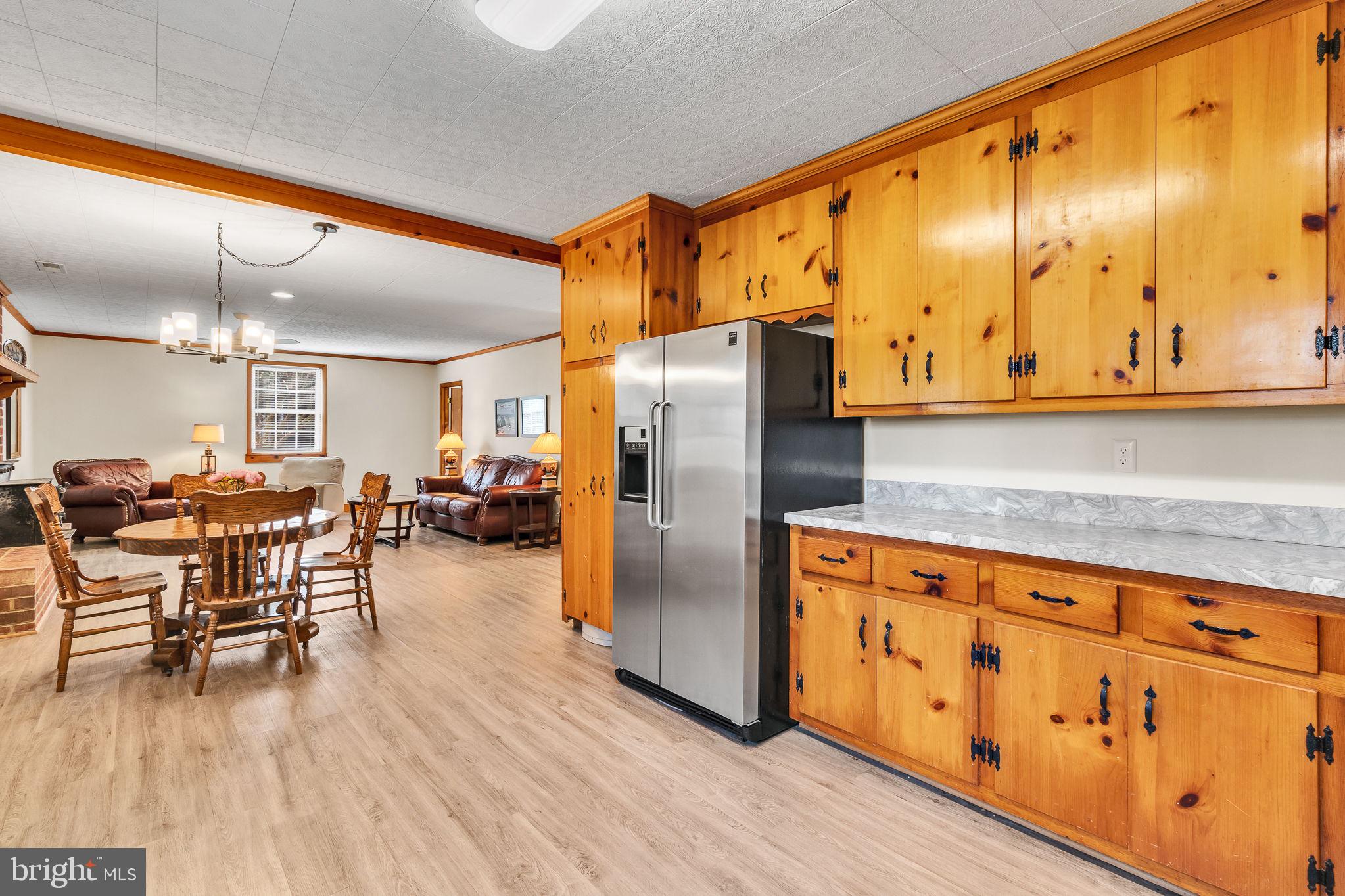 239 Lane Road Reedville, VA 22539 - Photo 10 of 61 a kitchen with stainless steel appliances granite countertop a refrigerator a stove and a wooden cabinets