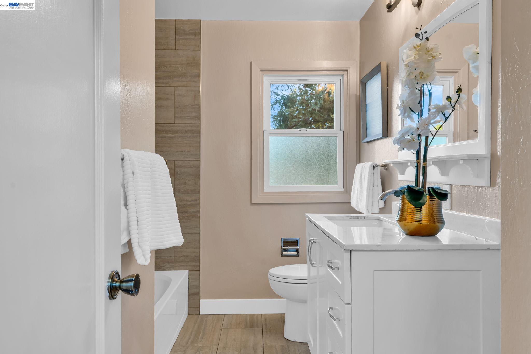4628 Fieldbrook Road Oakland, CA 94619 - Photo 25 of 40 a bathroom with a sink toilet and window