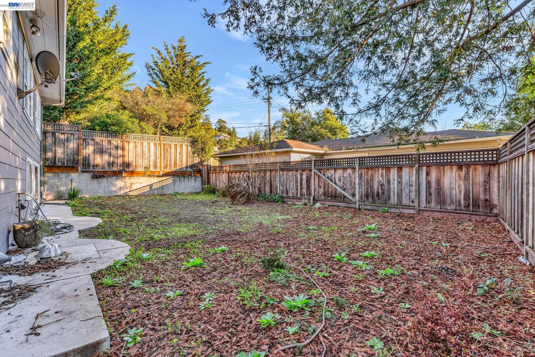 4628 Fieldbrook Road Oakland, CA 94619 - Photo 36 of 40 a view of a backyard with large trees and wooden fence