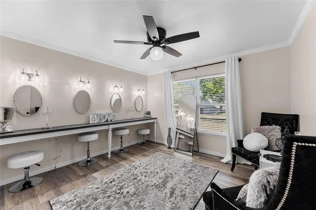 a large room with a table chairs and a ceiling fan