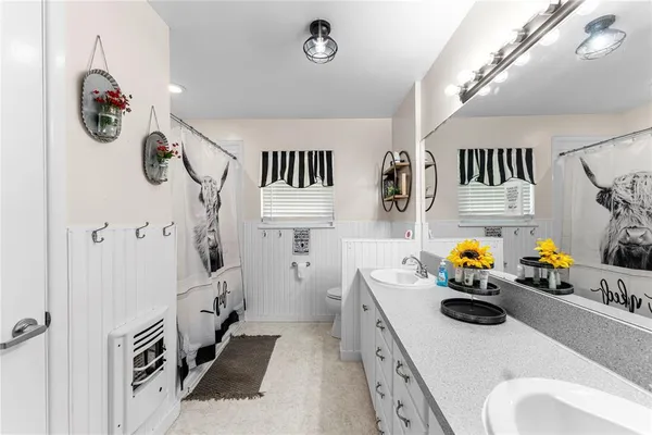 a bathroom with a sink a mirror and shower