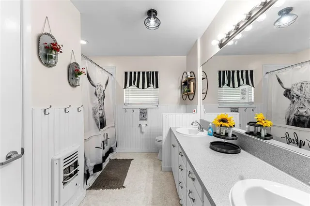 a bathroom with a sink a mirror and shower
