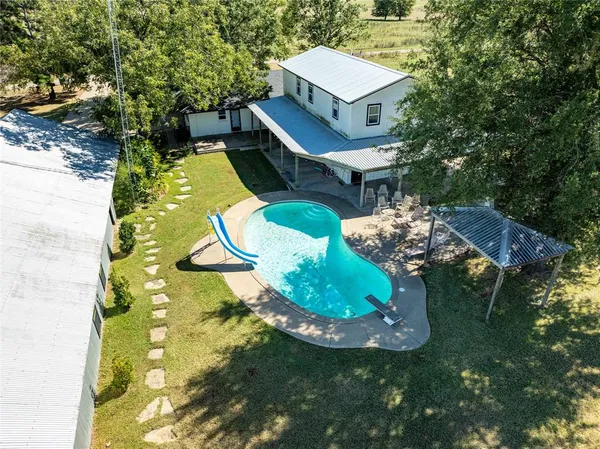 a aerial view of a house with a yard basket ball court and outdoor seating
