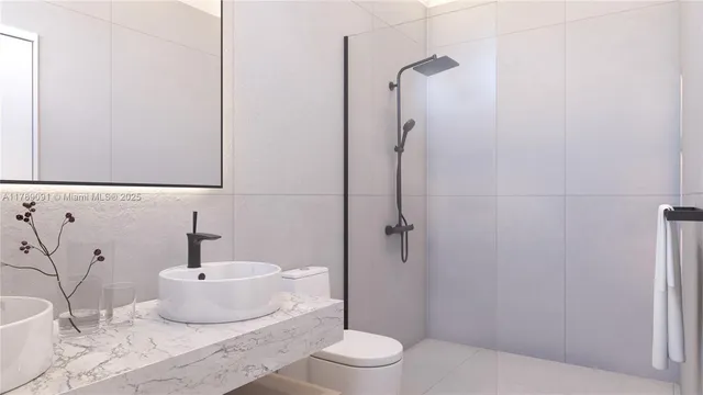 a bathroom with a granite countertop sink toilet and shower