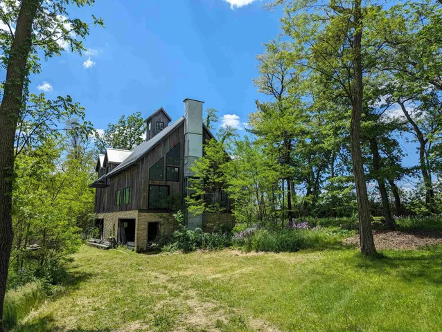 a brick house with lots of trees