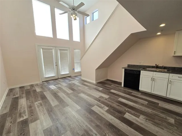 a view of a hallway with entryway and kitchen