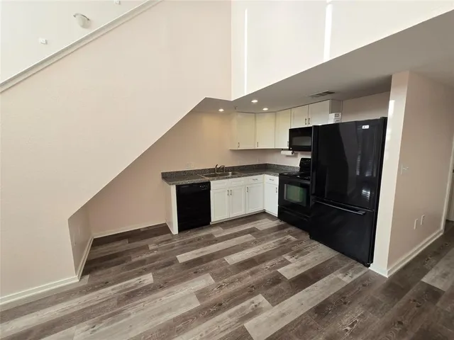 a kitchen with a refrigerator and a sink