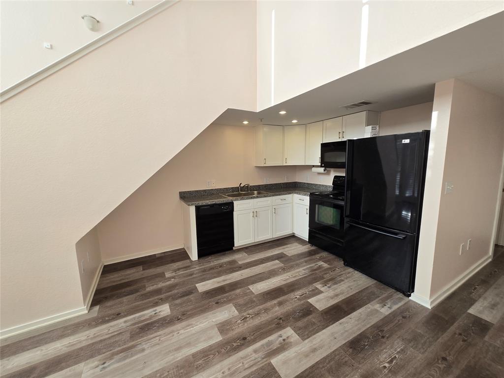 5111 Manett Street, Unit 207 Dallas, TX 75206 - Photo 3 of 10 a kitchen with a refrigerator and a sink