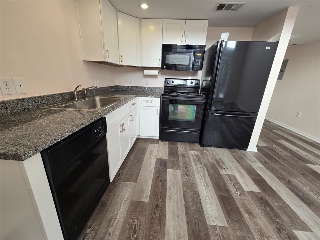 5111 Manett Street, Unit 207 Dallas, TX 75206 - Photo 4 of 10 a kitchen with stainless steel appliances a refrigerator sink and microwave