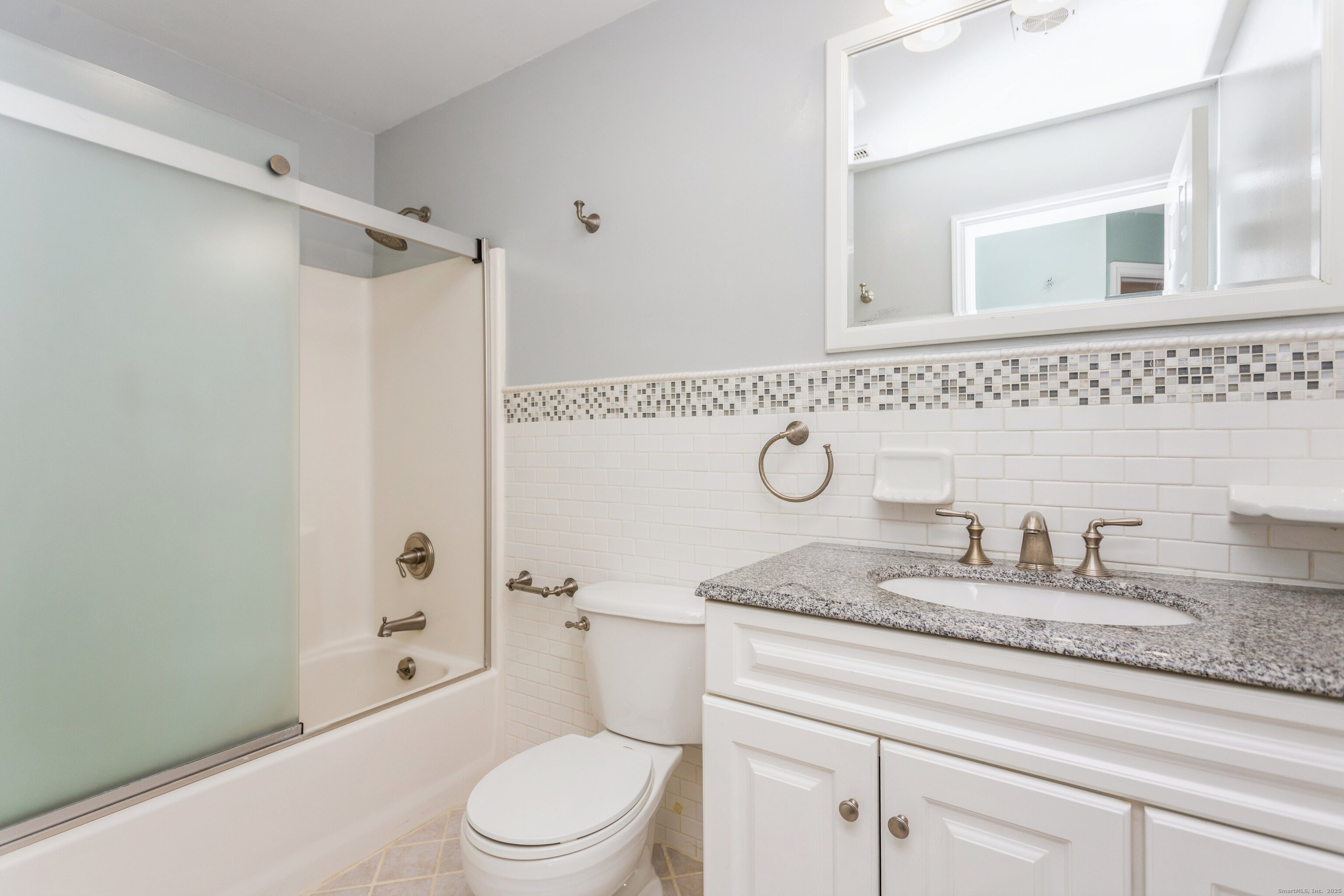 11 Scuppo Road, Unit 204 Danbury, CT 06811 - Photo 12 of 17 a bathroom with a granite countertop sink a toilet and a shower