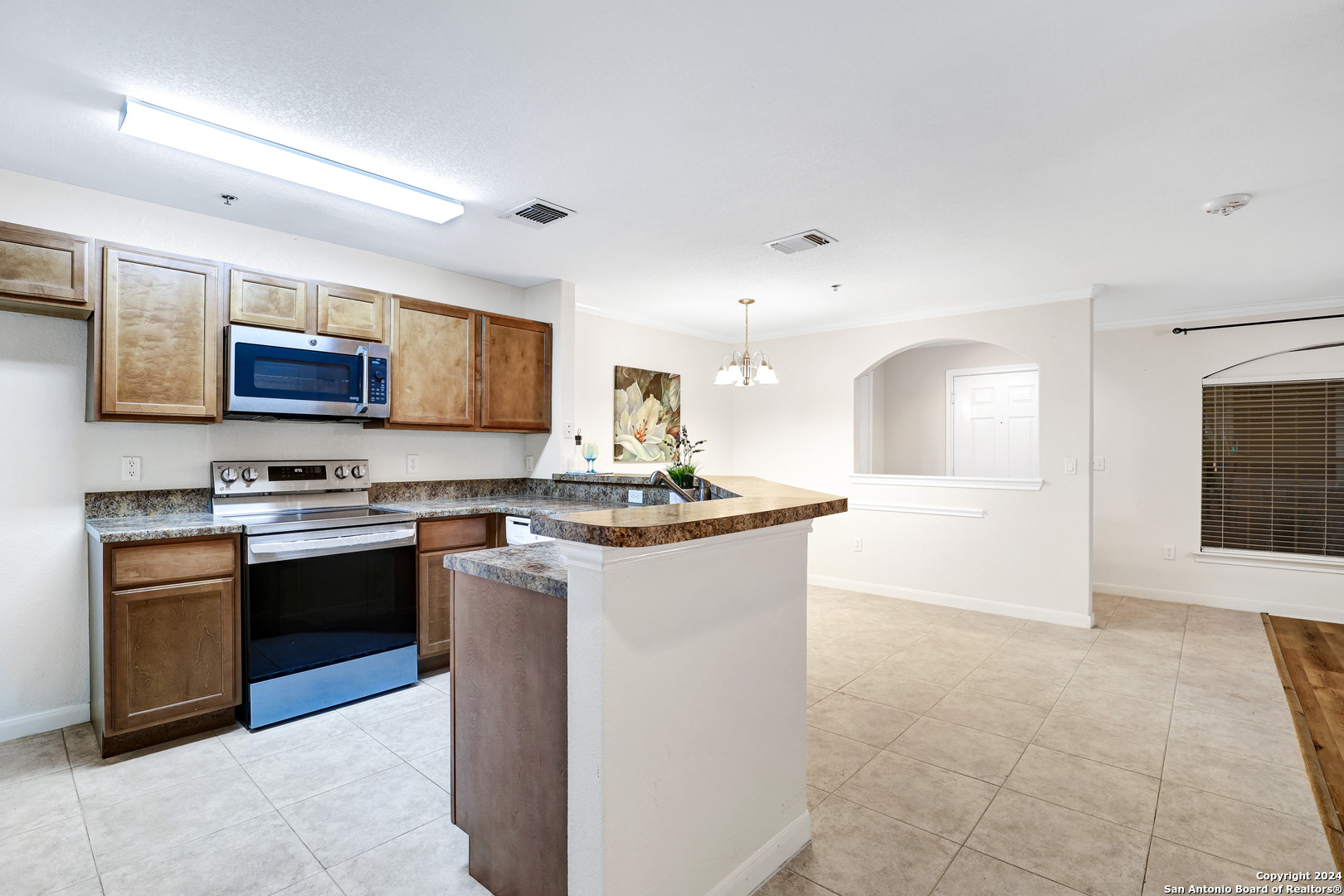 7323 Snowden Road, Unit 3108 San Antonio, TX 78240 - Photo 16 of 34 a large kitchen with stainless steel appliances granite countertop a stove and a sink