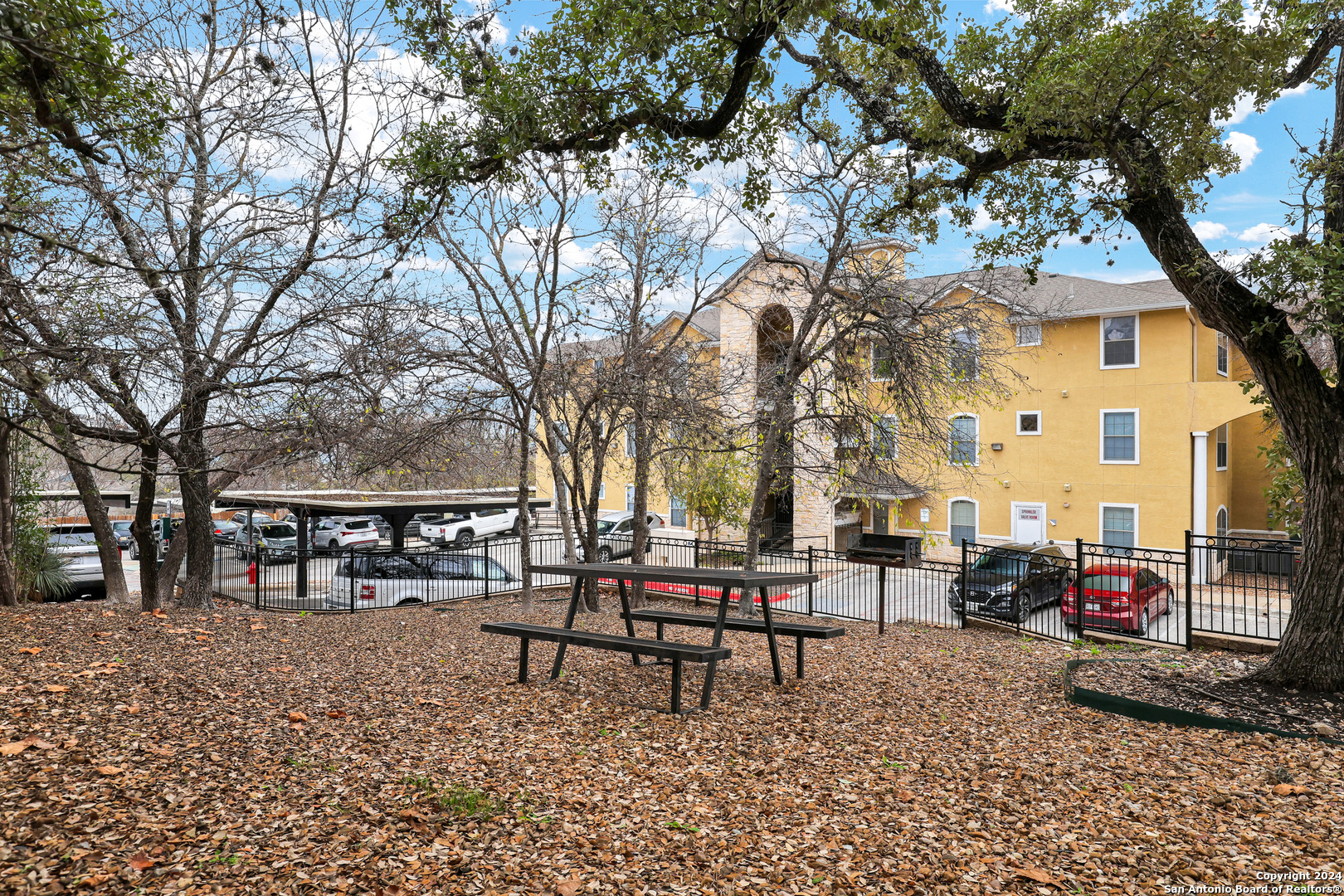 7323 Snowden Road, Unit 3108 San Antonio, TX 78240 - Photo 2 of 34 a swimming pool with outdoor seating and trees