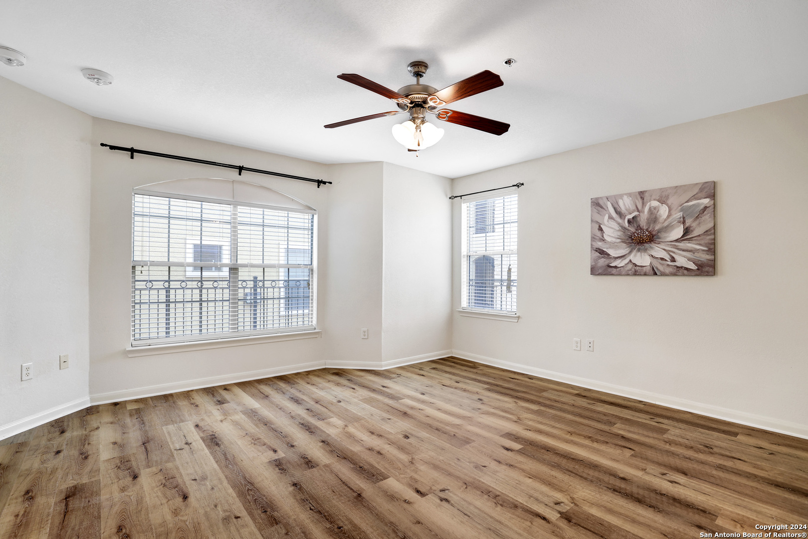 7323 Snowden Road, Unit 3108 San Antonio, TX 78240 - Photo 21 of 34 a view of an empty room with a window and wooden floor