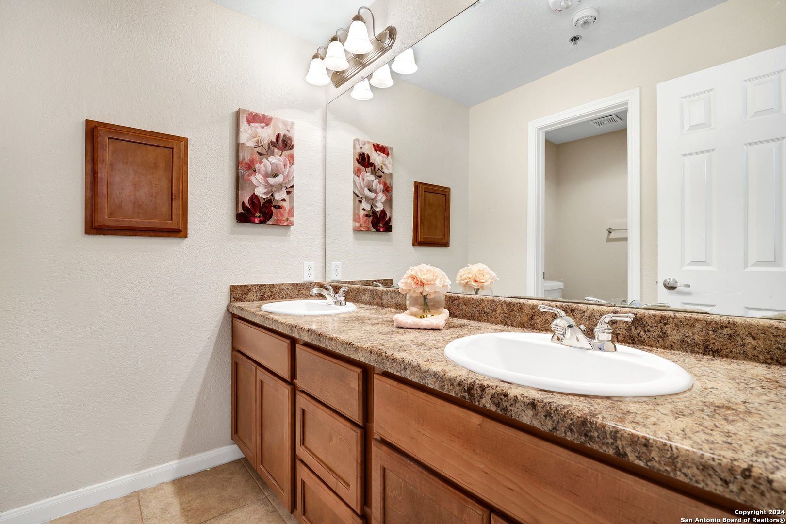 7323 Snowden Road, Unit 3108 San Antonio, TX 78229 - Photo 22 of 31 a bathroom with a granite countertop sink a large mirror and a