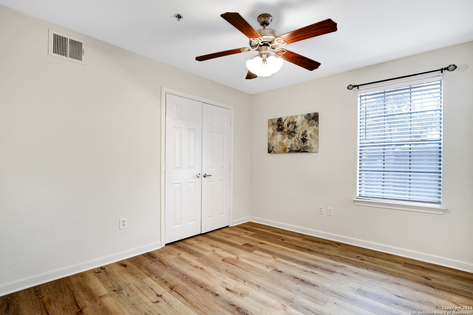 7323 Snowden Road, Unit 3108 San Antonio, TX 78229 - Photo 25 of 31 a view of a big room with wooden floor and windows