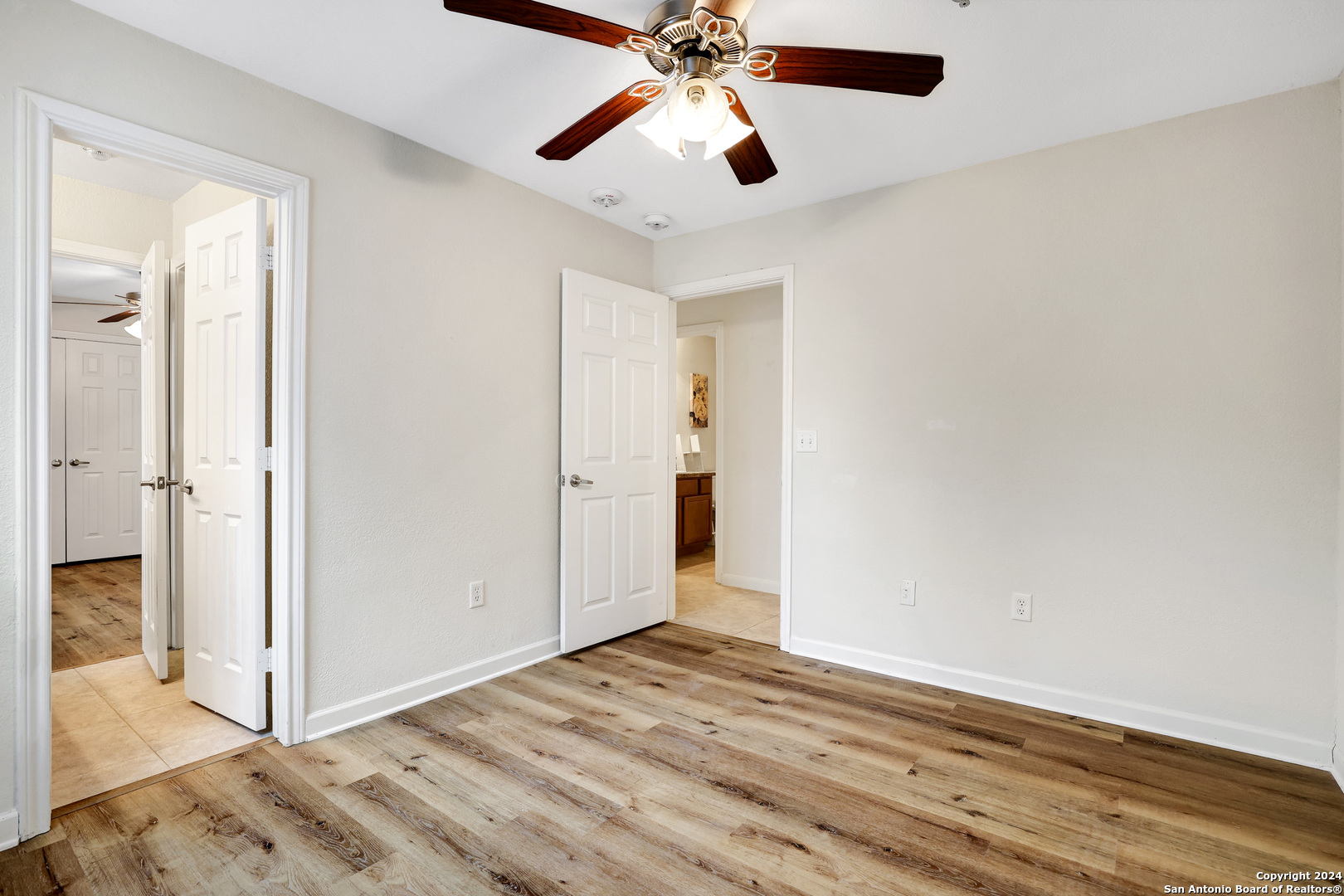7323 Snowden Road, Unit 3108 San Antonio, TX 78229 - Photo 26 of 31 a view of a room with wooden floor and a ceiling fan