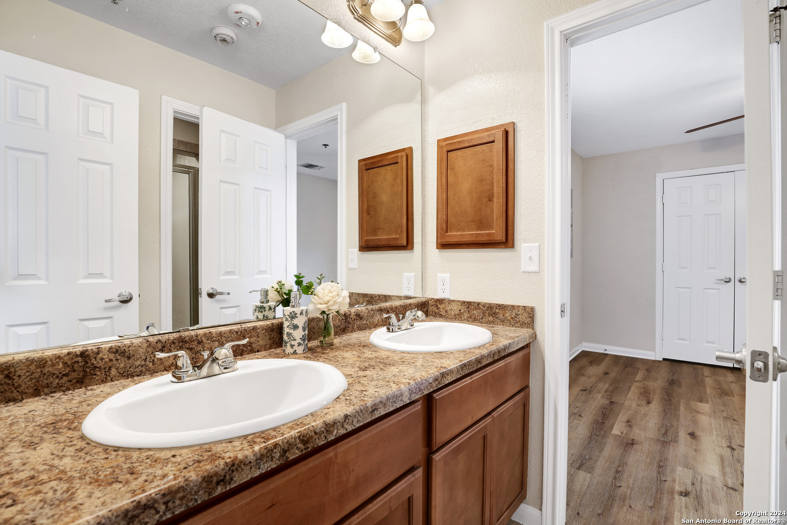 7323 Snowden Road, Unit 3108 San Antonio, TX 78229 - Photo 27 of 31 a bathroom with a granite countertop sink and a mirror