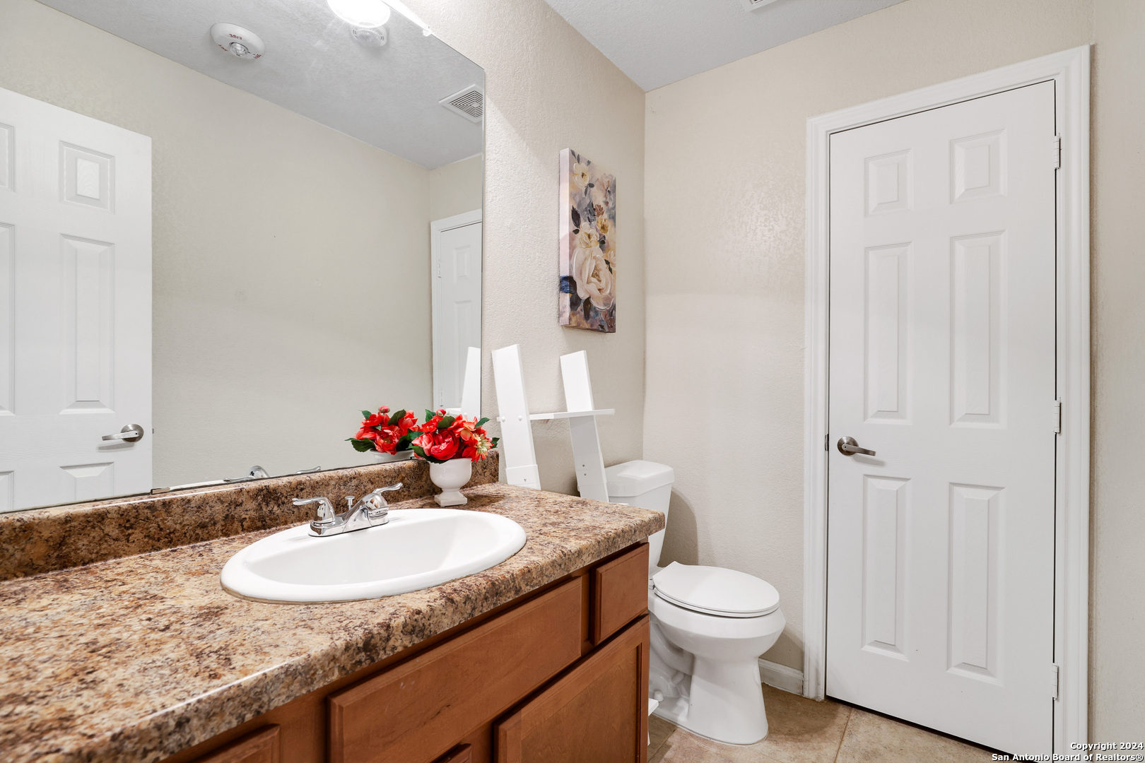 7323 Snowden Road, Unit 3108 San Antonio, TX 78240 - Photo 31 of 34 a bathroom with a granite countertop sink toilet and a mirror