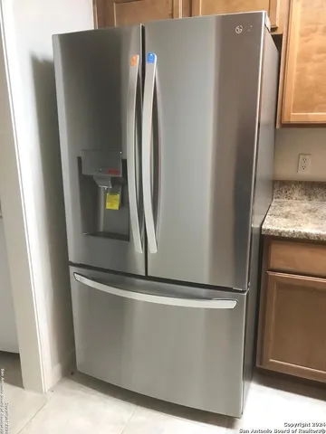 a view of a refrigerator in kitchen