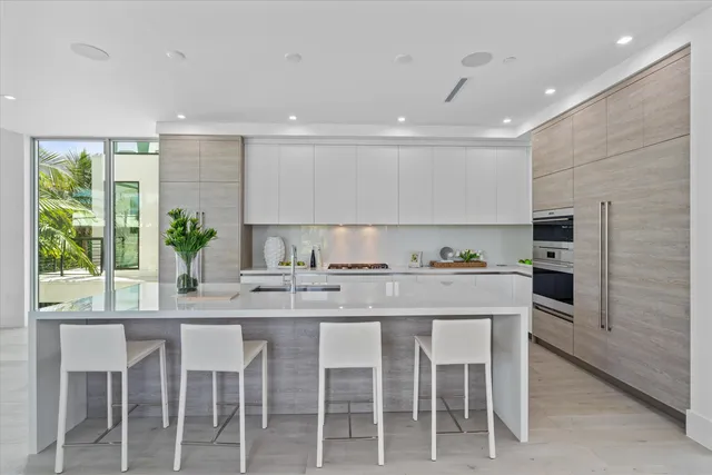 a kitchen with granite countertop a sink cabinets and window