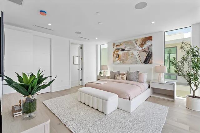 a bedroom with a large bed and a flat screen television