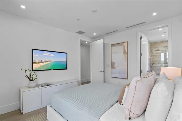 a bathroom with a granite countertop sink a toilet a mirror and shower