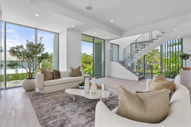 a living room with furniture and a potted plant