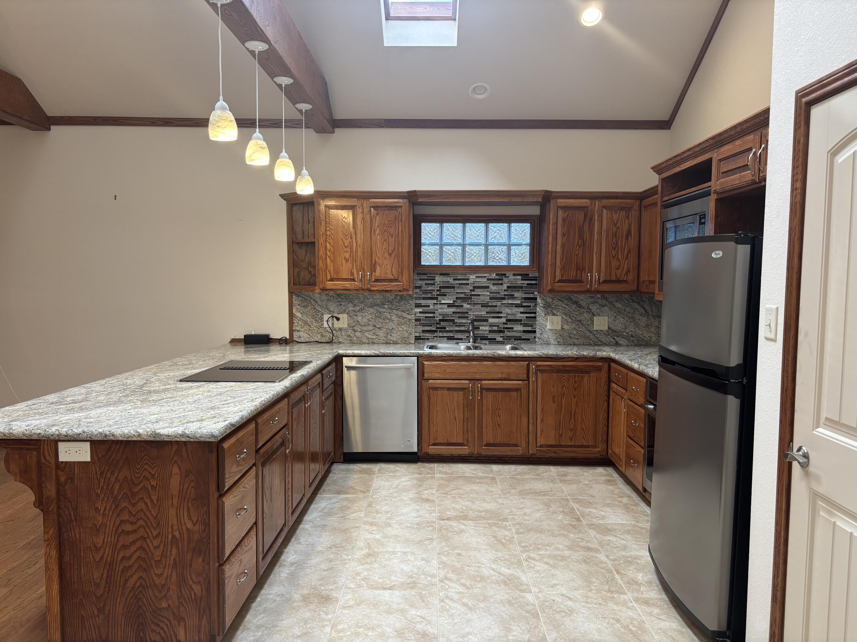 33 West Lakeshore Drive Ransom Canyon, TX 79366 - Photo 22 of 48 a kitchen with stainless steel appliances granite countertop a sink stove and refrigerator