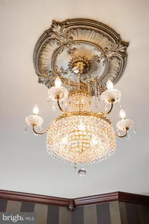 a kitchen with stainless steel appliances kitchen island granite countertop a refrigerator a sink dishwasher a stove and a dining table with wooden floor