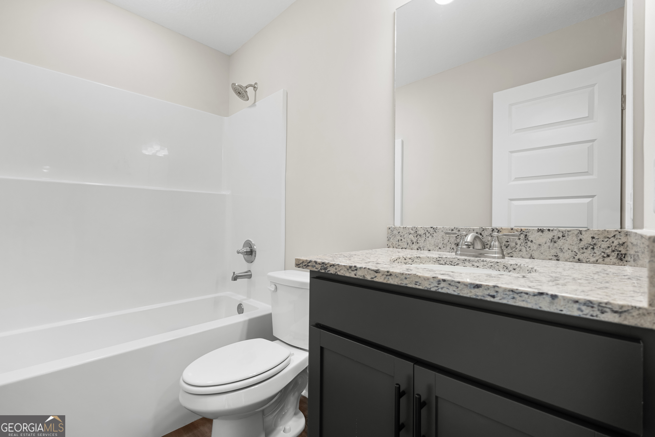 110 Enclave Court Statesboro, GA 30458 - Photo 11 of 16 a bathroom with a granite countertop sink a toilet and a bathtub