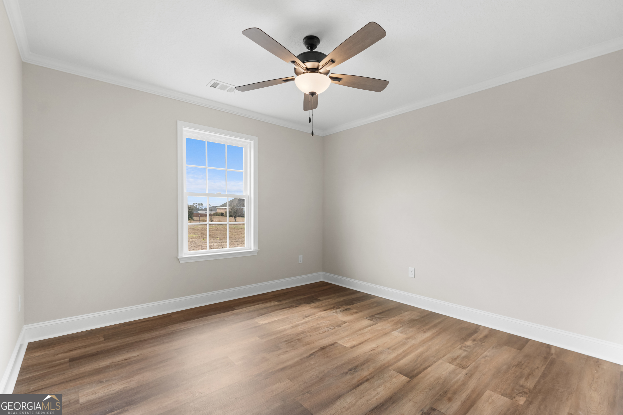 110 Enclave Court Statesboro, GA 30458 - Photo 12 of 16 an empty room with wooden floor and ceiling fan